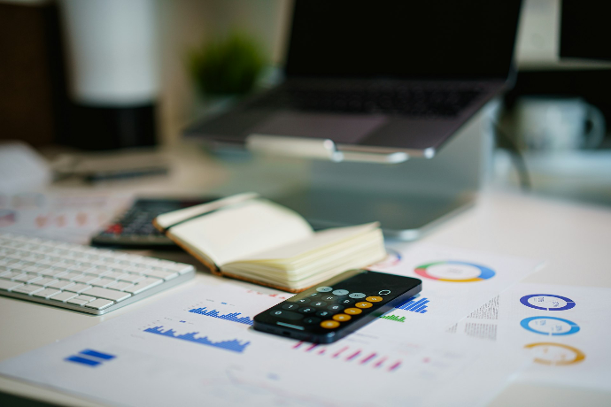 a calculator sitting on top of a table next to a book